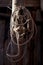 Twisted rope hanging on a wooden pole in the barn