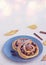 Twisted yeast buns with apples, raisins and cinnamon on a gray plate on a light concrete background. Harvest apples