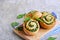 Twisted yeast buns stuffed with nettles, green onions and cheese on a wooden board