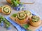 Twisted yeast buns stuffed with nettles, green onions and cheese on a wooden board