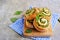 Twisted yeast buns stuffed with nettles, green onions and cheese on a wooden board