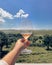 Twisting glass of rose wine, vineyard in the background