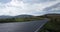 Twisty Road Sign Panning Mountain Road Time-lapse. a panning right time-lapse of a twisty road sign on the roadside with