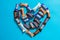 Twix, Milky Way, Snickers, Bounty, Mars popular mini candy chocolate bars on blue background in heart shape. Love concept.