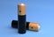 Two AA size batteries isolated on blue background close up, carbon zinc batteries, rechargeable batteries, mockup. 3D rendering