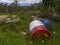 Two abandoned and battered steel barrels