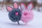 Two abstract rabbit toys on the snow