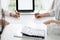 Two accountants using a laptop computer for counting taxes at white desk in office. Teamwork in business audit and