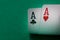 Two aces poker cards close up on a green table