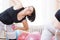 Two Active Fitness Girls Exercising With Barbells indoors in Gym