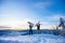 Two active friends snowboarder and skier standing on mountain top blue sky sunrise. Concept ski resort winter forest