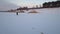 Two active and funny dogs running on the frozen lake towards their master