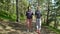 Two active women do Nordic walking in the Park. Tracking shot