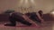 Two active women synchronously doing yoga exercise twine
