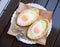 Two Adjarian khachapuries lying on white plate. Cooked from chees, egg yolk