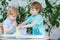 Two adorable boys making experiment with colorful bubbles