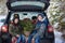 Two adorable brothers sitting in car at snowly winter forest. Concept holiday vacation