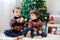 Two adorable children, boy brothers, eating cookies and drinking