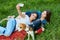 Two adorable girls posing with their dog in park.