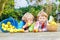 Two adorable little children eating apples in home\'s garden, out