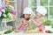 Two adorable little girls in aprons preparing delicious salad