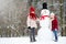 Two adorable little girls building a snowman together in beautiful winter park. Cute sisters playing in a snow.