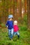 Two adorable little sisters hiking in a forest