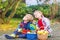 Two adorable little twin kids picking apples