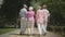 Two adorable mature couples walking and talking in the park. Double date of senior couples. Friendly company resting