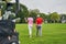 Two adult Caucasian golf players walking ahead