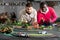 Two adult men playing with childrens slot car racing track
