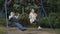 Two adult people swings in slowmotion