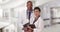 Two African American doctors posing for a portrait while holding their tablets