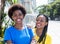 Two african american girlfriends laughing in the city