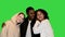 Two African American teens having fun with their Caucasian friend on a Green Screen, Chroma Key.