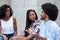 Two african american women talking with friend from Africa