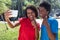 Two african american young adults taking selfie