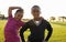 Two African elementary schoolgirls pose to camera in a field