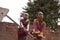 Two African Girls Having a Hard Time Pumping Water From The Public Well