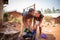 Two african girls wash clothes by hand using soap and a bucket, traditional life in africa