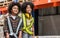 Two African little boy, girl kids standing in warehouse, dream to be architect, engineer, worker or business owner, smiling and