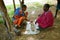 two African men in the national dress of the Maasai tribe play mancala