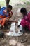 two African men in the national dress of the Maasai tribe play mancala