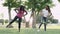 Two african women exercising with rubber band at dawn in public park