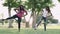 Two african women exercising with rubber band at dawn in public park