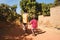 Two African Young Boys Walk Together in a Typical African Village