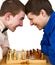Two aggressive chess opponents under chess board