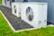 Two air source heat pumps installed outside of new and modern city house