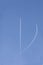 Two aircrafts in the ski make a graphic sign with condensation trails with copy space for your text