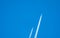 Two airplane with white condensation tracks. Jet plane on clear blue sky with vapor trail. Travel by aeroplane concept. Trails of